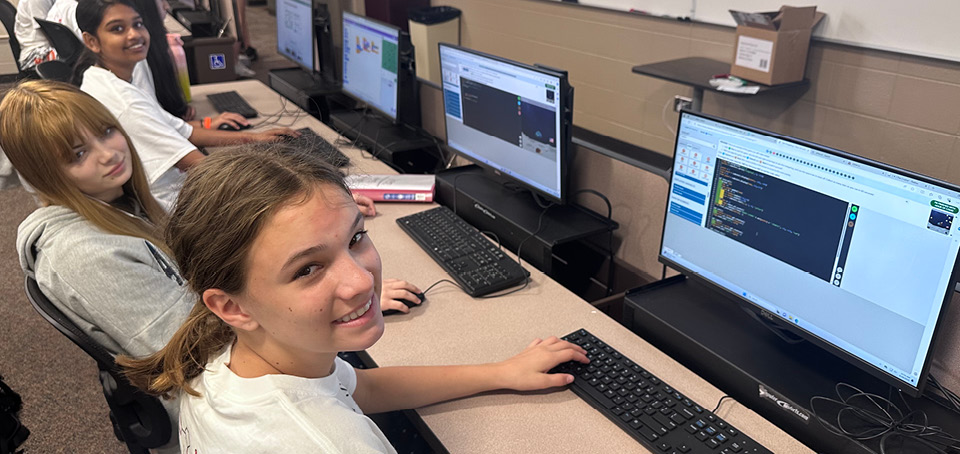 Group of students sitting in front of computers